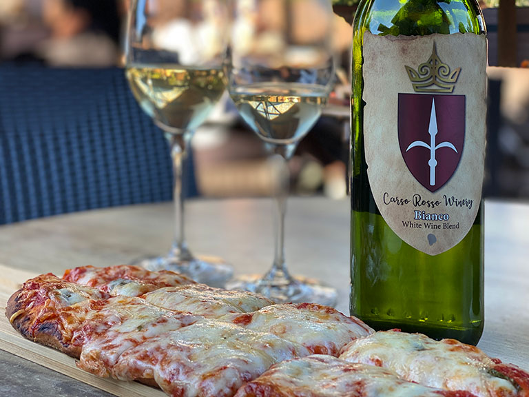 Pizza and Wine and on Carso Rosso Winery's patio